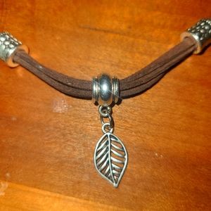 Handmade leather necklace with silver beads and pendant.